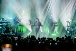 Die Bühne im unteren Domgarten ist in blaugrünes Licht getaucht. Dort spielt die Band "ClockClock", vorn steht mit ausgebreiteten Armen Frontmann Bojan „Boki“ Kalajdzic
