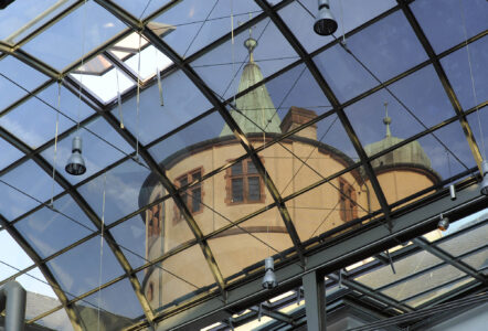 Durch das Glasdach des Innenhofs gesehener Turm des Historischen Museums der Pfalz